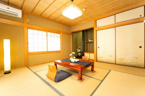 a living room with a table and a door at Awaji Seaside Resort in Iwaya 3000 in Awaji