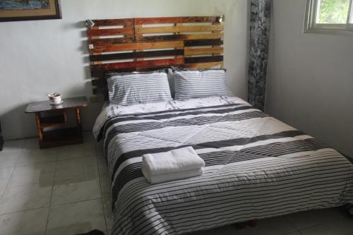a bed with two towels on it in a room at Maraño's Home in Legazpi