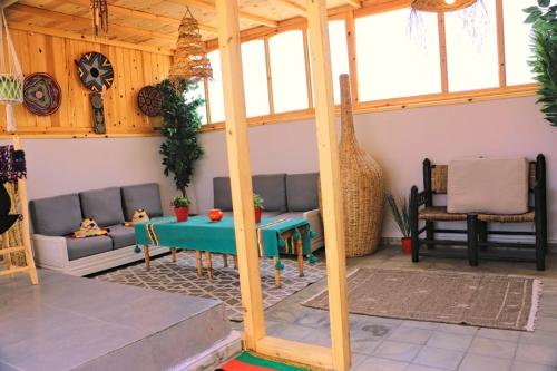 a living room with a couch and a table at Dar lhadja in El Jadida