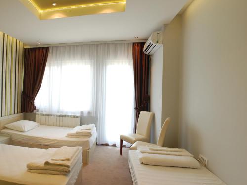 a hotel room with two beds and a window at Holiday Park CFK in Vrbas
