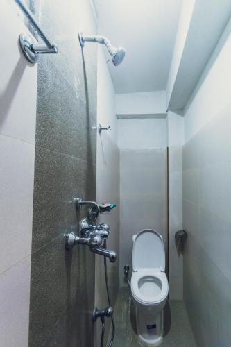 a small bathroom with a toilet and a shower at Shristi Hotel & Lodge in Bandīpur