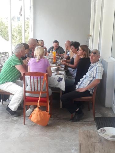 un groupe de personnes assises à une table dans l'établissement Sweet night, à Kazbegi