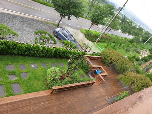 an overhead view of a garden with benches and plants at Grace River House Block A - Couple Room in Hoengseong