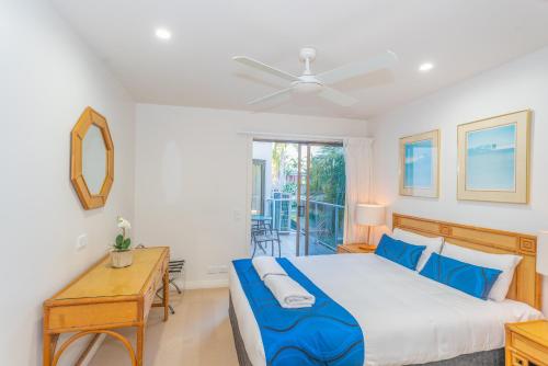 Ένα ή περισσότερα κρεβάτια σε δωμάτιο στο Noosa Boutique Apartments & Elkhorn Villas