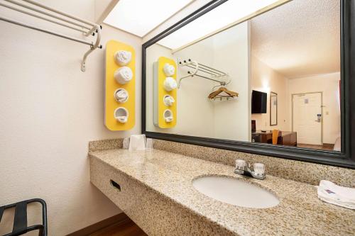 a bathroom with a sink and a large mirror at Motel 6-Covington, TN in Covington