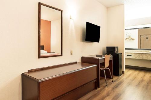 a hospital room with a mirror and a desk at Motel 6-Covington, TN in Covington