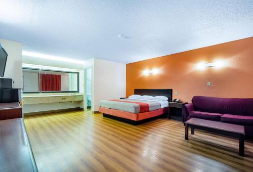 a hotel room with a bed and a couch at Motel 6-Covington, TN in Covington