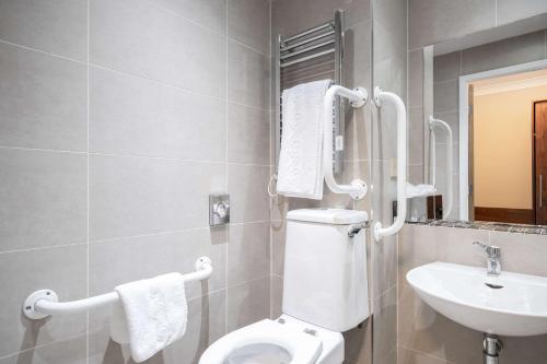 a bathroom with a toilet and a sink at Holiday Inn Newcastle South by IHG in Boldon