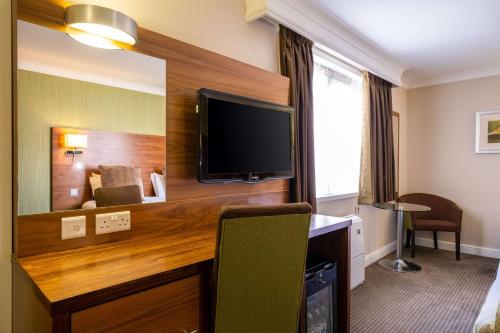 a hotel room with a flat screen tv on a wall at Holiday Inn Newcastle South by IHG in Boldon