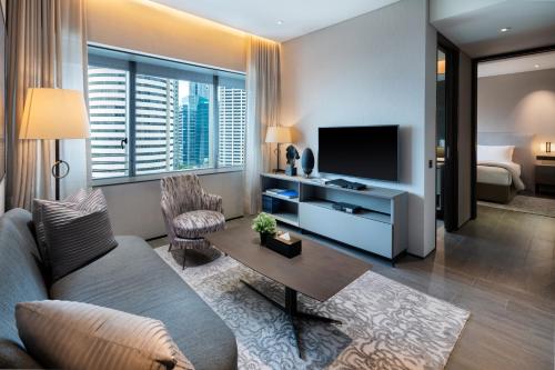 a living room filled with furniture and a tv at Dao by Dorsett AMTD Singapore in Singapore