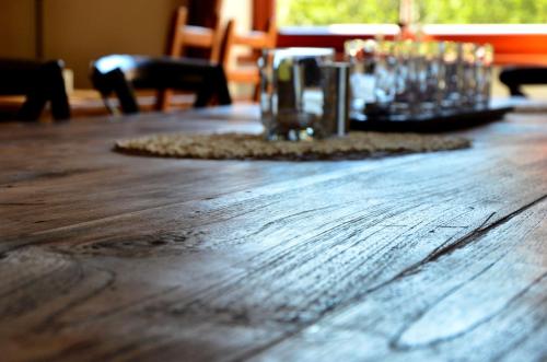 a wooden table with glasses on top of it at Hotel Stoh in Špindlerův Mlýn