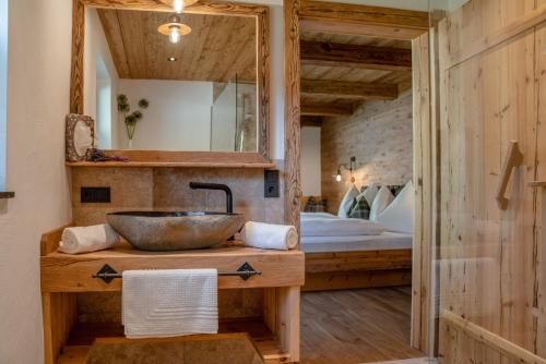 a bathroom with a sink and a mirror at Almchalet Linharterhof in Haus im Ennstal