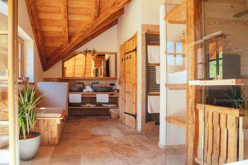 a room with wooden ceilings and a room with a desk at Almchalet Linharterhof in Haus im Ennstal