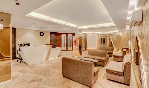 a lobby with couches and chairs and a table at Treebo Radhe Palace, Lake Town in Kolkata
