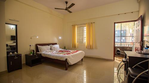 a bedroom with a bed and a window at Woodside residency in Thekkady