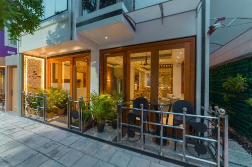 a store front with tables and chairs in a building at Samann Host in Hulhumale
