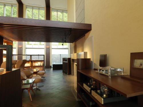 a living room with a table and some chairs at Jozankei Tsuruga Resort Spa Mori no Uta in Jozankei