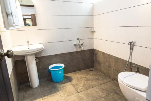a bathroom with a sink and a toilet at The Porch Inn Hotel/Service Apartments in Bengaluru