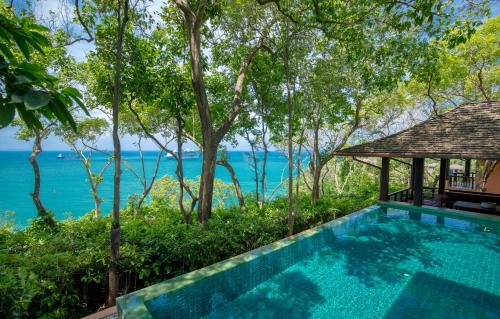 a swimming pool with a view of the water at Sri Panwa Phuket Luxury Pool Villa Hotel - SHA Plus in Panwa Beach