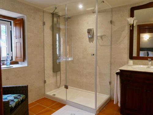 a shower with a glass door in a bathroom at Vida-Vi, Country House and B&B in Santa Catarina