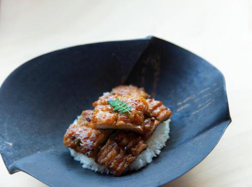 a plate of food with rice and meat on it at modern ryokan kishi-ke in Kamakura