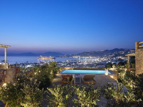a view of a swimming pool at night at Belvedere Mykonos - Hilltop Rooms & Suites - The Leading Hotels of the World in Mýkonos City