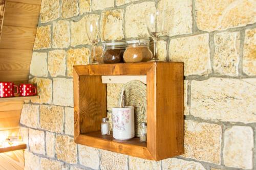 a wooden shelf on a stone wall at Etno selo Smrčevo brdo in Žabljak