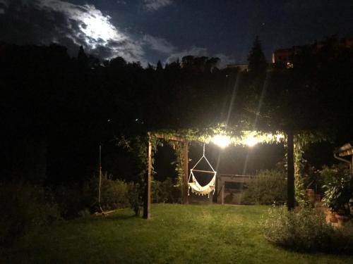 a gazebo with a hammock in a yard at night at Villa Porsenna in Chiusi