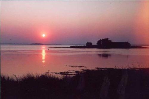 a sunset over a large body of water at LE LOFT in Séné