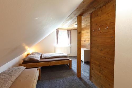 Schlafzimmer im Dachgeschoss mit einem Bett und einem Fenster in der Unterkunft chalupa Rejhotice in Loučná nad Desnou