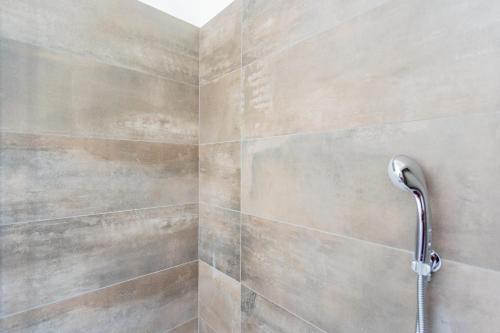 a shower with a shower head in a bathroom at Amazing Cernobbio - Lake Como by Rent All Como in Cernobbio