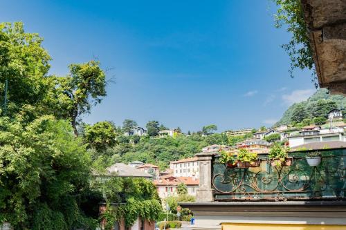 a view of a town with a hill in the background at Amazing Cernobbio - Lake Como by Rent All Como in Cernobbio