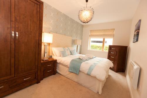a bedroom with a bed and a dresser and a window at Assaroe Falls in Ballyshannon