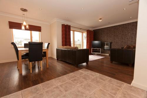 a living room with a table and a dining room at Assaroe Falls in Ballyshannon