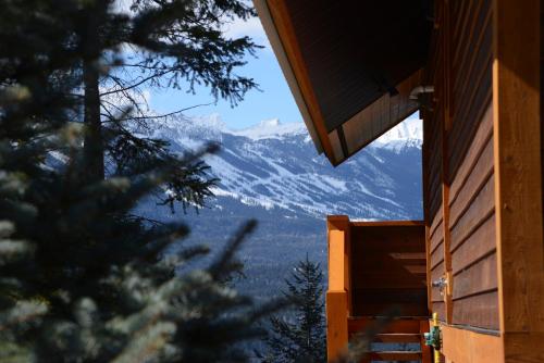 a view of a snow covered mountain from a house at Cedar House Restaurant & Chalets in Golden