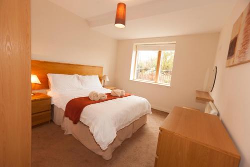 a bedroom with a bed with two stuffed animals on it at Assaroe Falls in Ballyshannon
