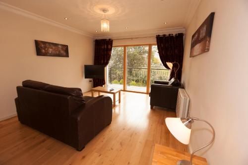 a living room with a couch and a television at Assaroe Falls in Ballyshannon