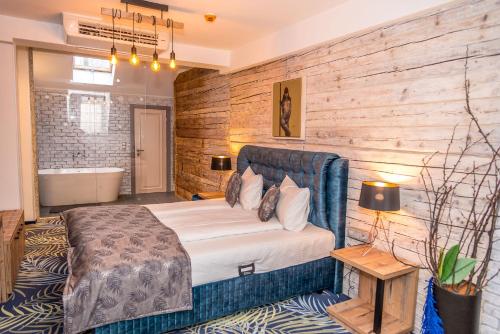 a bedroom with a bed and a bath tub in it at ART Hotel in Sibiu