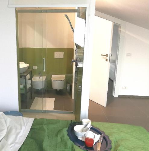 a bathroom with a toilet and a glass shower at Villa Arillà con piscina e padel in Marina di Ragusa