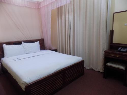 En eller flere senger på et rom på Belline Hotel Ishaka