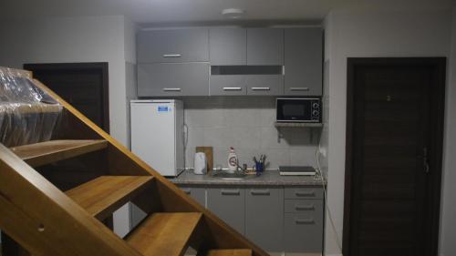 una pequeña cocina con nevera blanca y fregadero en Agroturystyka Zapiecek, en Iłża