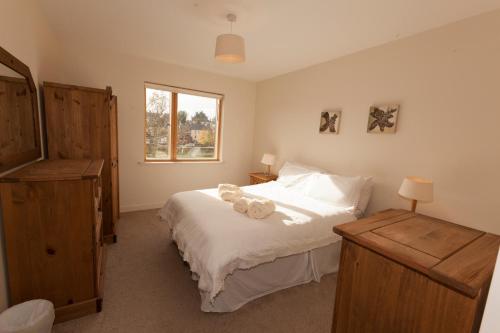 a bedroom with a bed with two teddy bears on it at Assaroe Falls in Ballyshannon