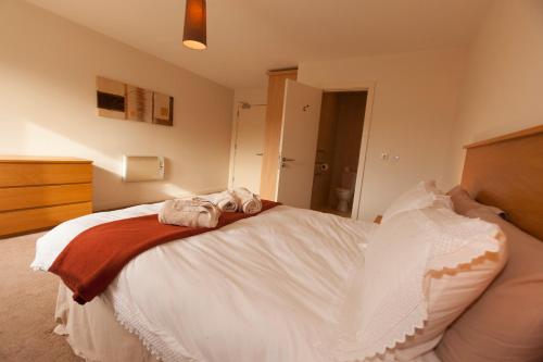 a bedroom with a bed with towels on it at Assaroe Falls in Ballyshannon