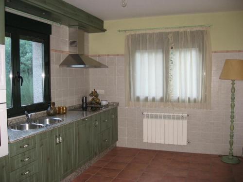 a kitchen with a sink and a window at En plena Ribera Sacra CasaCocó in Ferreira