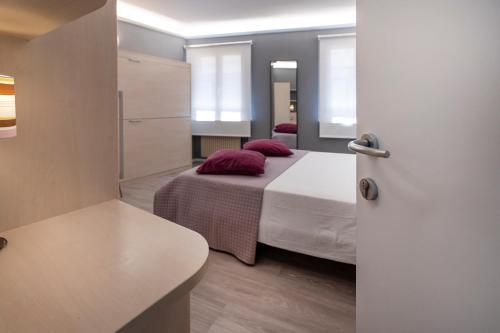 Postel nebo postele na pokoji v ubytování Albergo Aurora