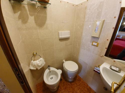 a bathroom with a toilet and a sink at Casa Alla Fenice in Venice