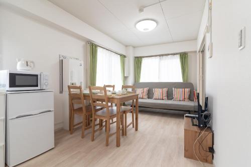 a kitchen and dining room with a table and chairs at Uhome Iriya Apartment in Tokyo