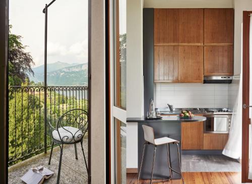 a kitchen with a balcony with a view at Hotel Belvedere in Bellagio