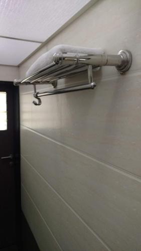 a towel rack on the side of a wall at Pals Hotel in Mumbai