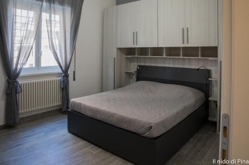 מיטה או מיטות בחדר ב-Nido di Pina